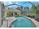 Backyard view with an in-ground pool, lounge area, and outdoor kitchen at 1033 Pearl Tree Rd, Deltona, FL 32725
