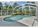 Enclosed pool area surrounded by mature landscaping, offering privacy at 1033 Pearl Tree Rd, Deltona, FL 32725