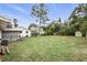 Green backyard features a fence, shed, and plenty of space for outdoor activities and potential landscaping at 104 Hester Ave, New Smyrna Beach, FL 32168