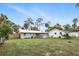 Fenced-in backyard offers privacy and space, complemented by lush greenery and mature trees enhancing the outdoor experience at 104 Hester Ave, New Smyrna Beach, FL 32168