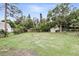 Expansive backyard featuring green grass and a storage shed, perfect for outdoor activities and storage at 104 Hester Ave, New Smyrna Beach, FL 32168