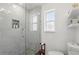 Bathroom featuring a glass door shower, marble tile, and stylish fixtures at 104 Hester Ave, New Smyrna Beach, FL 32168