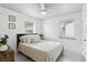 Bedroom features a ceiling fan, neutral decor, and bright natural light at 104 Hester Ave, New Smyrna Beach, FL 32168
