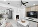Modern living room featuring a fireplace and open layout to kitchen and stainless appliances at 104 Hester Ave, New Smyrna Beach, FL 32168