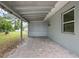 Covered back patio with brick flooring, offers shade and an outdoor space for relaxation and entertaining at 1044 Deltona Blvd, Deltona, FL 32725
