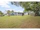 Wide backyard featuring a shed, grassy lawn, and plenty of open space for outdoor activities and enjoyment at 1044 Deltona Blvd, Deltona, FL 32725