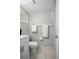 Clean bathroom featuring a toilet, a vanity with sink, and towel racks for everyday convenience at 1044 Deltona Blvd, Deltona, FL 32725