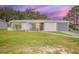 Charming single-story home featuring a well-manicured lawn and attached garage at 1044 Deltona Blvd, Deltona, FL 32725