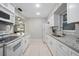 Bright kitchen featuring white cabinets, granite counters, and stainless appliances at 1044 Deltona Blvd, Deltona, FL 32725