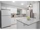 White kitchen features granite countertops and stainless steel appliances at 1044 Deltona Blvd, Deltona, FL 32725