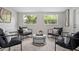 Inviting living room featuring stylish seating, soft rug, and a serene ambiance with natural light at 1044 Deltona Blvd, Deltona, FL 32725