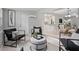 Cozy sitting room with stylish chairs, ottoman, and open layout to the dining area at 1044 Deltona Blvd, Deltona, FL 32725
