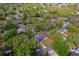 Overhead view of a charming home nestled among lush trees, featuring a long driveway and green lawn at 105 Laguna Ct, Sanford, FL 32773