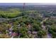Aerial view of a residential area with arrow pointing to a home, showcasing streets, homes, and surrounding lush greenery at 105 Laguna Ct, Sanford, FL 32773