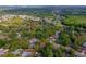 Expansive aerial view of a residential neighborhood with arrow pointing to a home, lush greenery and tree-lined streets at 105 Laguna Ct, Sanford, FL 32773
