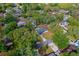 Aerial view showcases a cozy home with a sprawling yard, mature trees, and a private driveway at 105 Laguna Ct, Sanford, FL 32773