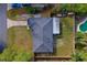 Overhead shot of a single-Gathering home, showcasing the roof, driveway, backyard with a pool, and surrounding green spaces at 105 Laguna Ct, Sanford, FL 32773