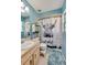 Bathroom featuring a single sink vanity, toilet, and shower/tub with a decorative cow shower curtain at 105 Laguna Ct, Sanford, FL 32773