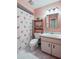 Bathroom featuring a single sink vanity, toilet, and shower/tub with a flamingo shower curtain at 105 Laguna Ct, Sanford, FL 32773