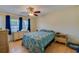 Bedroom with a ceiling fan, laminate flooring, and large window at 105 Laguna Ct, Sanford, FL 32773