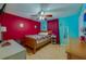Bedroom with wood laminate flooring, a ceiling fan, and red and blue walls at 105 Laguna Ct, Sanford, FL 32773