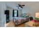 Bedroom with wood laminate flooring, a ceiling fan, and a metal bed frame at 105 Laguna Ct, Sanford, FL 32773