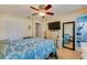 Bedroom with a ceiling fan, laminate flooring, large mirror, and ensuite bath at 105 Laguna Ct, Sanford, FL 32773
