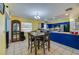 Sunlit dining space with modern seating, tiled floors, and an open view into the adjacent kitchen at 105 Laguna Ct, Sanford, FL 32773