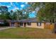 Well-kept home with a green lawn, blue shutters and brick facade accents at 105 Laguna Ct, Sanford, FL 32773
