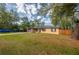 Charming single-story home featuring a well-maintained lawn, mature trees, and a classic brick facade at 105 Laguna Ct, Sanford, FL 32773