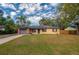 Charming single-story home with brick accents, a well-maintained lawn, and a driveway leading to a single-car garage at 105 Laguna Ct, Sanford, FL 32773