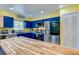 Bright kitchen with stainless steel appliances, blue cabinetry, and a butcher block island at 105 Laguna Ct, Sanford, FL 32773
