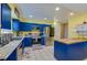 Vibrant kitchen featuring blue cabinetry, stainless steel appliances, and ample counter space at 105 Laguna Ct, Sanford, FL 32773