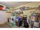 Laundry room featuring a washer, dryer, water heater, and plenty of shelving at 105 Laguna Ct, Sanford, FL 32773