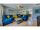 Comfortable living room with a large blue sectional sofa, a ceiling fan, and neutral flooring at 105 Laguna Ct, Sanford, FL 32773
