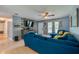 Comfortable living room with a blue sectional, stylish decor, and a view into the dining area at 105 Laguna Ct, Sanford, FL 32773