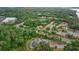 Wide aerial view of a residential community surrounded by trees and next to a sandy beach at 110 Cypress Woods Ct # 2B, Deltona, FL 32725