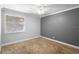 Bedroom features a carpeted floor, gray accent wall, and a ceiling fan at 110 Cypress Woods Ct # 2B, Deltona, FL 32725