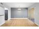 A combined living and dining room, featuring wood floors and modern accents at 110 Cypress Woods Ct # 2B, Deltona, FL 32725