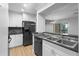Modern kitchen features granite countertops, stainless steel appliances, and access to the living area at 110 Cypress Woods Ct # 2B, Deltona, FL 32725