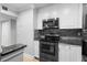 Updated kitchen features modern stainless appliances, stylish backsplash and stone countertops at 110 Cypress Woods Ct # 2B, Deltona, FL 32725