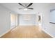 A bright living room with wood floors and sliding glass doors to a lanai at 110 Cypress Woods Ct # 2B, Deltona, FL 32725