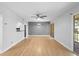 Open-concept living space with wood floors, modern ceiling fan, and sliding door access to balcony at 110 Cypress Woods Ct # 2B, Deltona, FL 32725