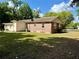 Back of home featuring brick and siding, air conditioning unit and spacious yard at 111 S Delaware Ave, Deland, FL 32720