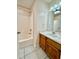 Bathroom with tiled flooring features a bathtub and vanity with sink at 111 S Delaware Ave, Deland, FL 32720