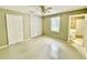 Bedroom with door, closet, window, and adjoining bathroom at 111 S Delaware Ave, Deland, FL 32720