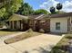 Brick ranch-style home featuring attached garage and concrete driveway at 111 S Delaware Ave, Deland, FL 32720