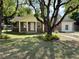 Charming brick home featuring a well-manicured lawn and mature landscaping at 111 S Delaware Ave, Deland, FL 32720