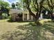 Charming brick home with well-maintained lawn and mature shade tree at 111 S Delaware Ave, Deland, FL 32720