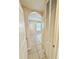 Hallway with tiled flooring leads to a bedroom with an arched entryway at 111 S Delaware Ave, Deland, FL 32720